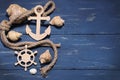 Marine attributes. Rope, frame, wooden anchor and steering wheel on a wooden background. Top vie Royalty Free Stock Photo