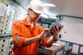 Marine chief engineer watching digital tablet in engine control room Royalty Free Stock Photo