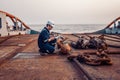 Marine chief officer or chief mate on deck of ship or vessel. He fills up ahts vessel checklist. Ship routine paperwork Royalty Free Stock Photo