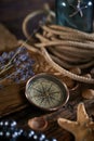 A marine concept with a bottle, starfish, seashells, rope, compass and paper scroll, pirate still life