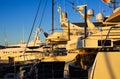 View beyond stern of ships on luxury yacht in mediterranean Harbour during sunset Royalty Free Stock Photo