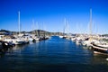 View over water on boat docks of mediterranean Harbour with sail ships against blue sky Royalty Free Stock Photo