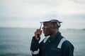 Marine Deck Officer or Chief mate on deck of vessel or ship with VHF walkie-talkie radio Royalty Free Stock Photo