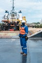 Marine deck officer with protective mask on seagoing vessel, with personal protective equipment