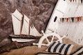 Marine decorations. Ship and wheel in sand.