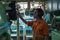 Marine engineer inspecting ship`s engine in engine control room