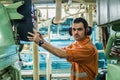 Marine engineer inspecting ship`s engine in engine control room Royalty Free Stock Photo