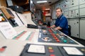 Marine engineer officer controlling vessel engines and propulsion in engine control room