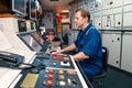 Marine engineer officer controlling vessel engines and propulsion in engine control room