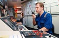 Marine engineer officer controlling vessel engines and propulsion in engine control room