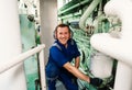 Marine engineer officer controlling vessel enginesand propulsion in engine control room ECR