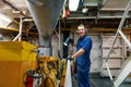 Marine engineer officer controlling vessel enginesand propulsion in engine control room ECR