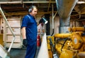 Marine engineer officer controlling vessel enginesand propulsion in engine control room ECR