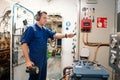 Marine engineer officer controlling vessel enginesand propulsion in engine control room ECR