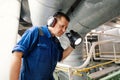 Marine engineer officer controlling vessel enginesand propulsion in engine control room ECR