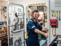 Marine engineer officer working in engine room Royalty Free Stock Photo