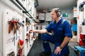 Marine engineer officer in engine control room ECR. He works in workshop