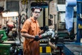 Marine engineer working in ship`s workshop in engine control room