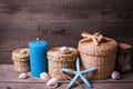 Marine items and blue candle on aged wooden background.