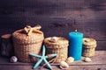 Marine items and blue candle on aged wooden background.