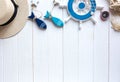 Marine items on wooden background. Sea objects: straw hat, swimsuit, fish, shells . flat lay, copy space Royalty Free Stock Photo