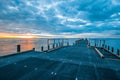 Pier and calm bay water at sunset. Royalty Free Stock Photo