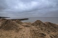 Marine landscape with sands in the blue hour in the rain. From the shore of the Black Sea. Pomorie, Bulgaria.