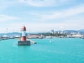 Marine lighthouse in clear weather. Turquoise sea