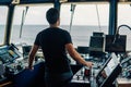 Marine navigational officer is maneuvering ship or vessel