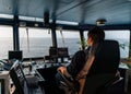 Marine navigational officer during navigational watch on Bridge . Work at sea Royalty Free Stock Photo