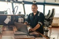 Marine navigational officer is using laptop or notebook at sea