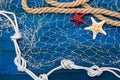 Marine network rope and starfish on a blue disk