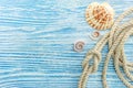 Marine rope and seashells on blue wooden background with copy sp Royalty Free Stock Photo