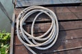 Marine ropes pile for towing ship on wooden closeup in the port. Royalty Free Stock Photo