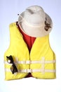 Marine safety equipment, flotation device and water activities concept with a yellow chapel life jacket and summer glasses