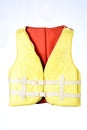 Marine safety equipment, flotation device and water activities concept with a yellow life jacket with red isolated on white