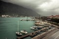 Marine sea port with moored luxury yachts and boats in medieval Kotor bay in Montenegro in overcast rainy autumn day Royalty Free Stock Photo