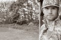 Marine, soldier in his army fatigues stands to attention at military base