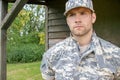 Marine, soldier in his army fatigues stands to attention at military base