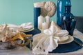 Marine style table setting - shells, starfish and blue glassware Royalty Free Stock Photo