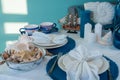 Marine style table setting - shells, starfish and blue glassware Royalty Free Stock Photo