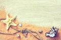 Marine theme background, sand, seashells, rope with knot Royalty Free Stock Photo