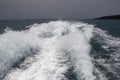 Marine travel ship tail photo. Stormy day seaside landscape. Motor boat trail with foam and splashing. Royalty Free Stock Photo