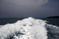 Marine travel ship tail photo. Stormy day seaside landscape. White foam on seawater surface. Motor boat trail Royalty Free Stock Photo