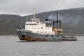 The marine tugboat sails along the Kola Bay water area