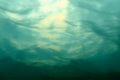 Marine underwater scene. Sea water surface, bottom view.