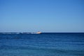 A motor boat is towing an inflatable raft with people in the Mediterranean off the coast of the island of Rhodes. Kolympia, Greece