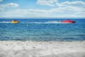 Marine water activities in the open air. Riding a banana in the ocean on a cable using a motor boat, copy space. Water sports at Royalty Free Stock Photo