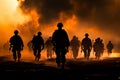 Marines in action, silhouetted by a fiery sunset, advance through smoke Royalty Free Stock Photo