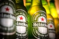 Marinette,WI / U.S.A. - Aug16,2019: Cold bottles of Heineken Beer with drops over green background. Heineken is the flagship produ